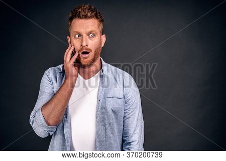 Astounded Redhead Young Handsome Male Has Stubble Looks With Shocked Expression Aside, Notices Somet
