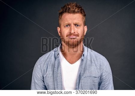 Horizontal Shot Of Attractive Male Model With Unhappy Expression Curves Lips As Feels Frustration, B