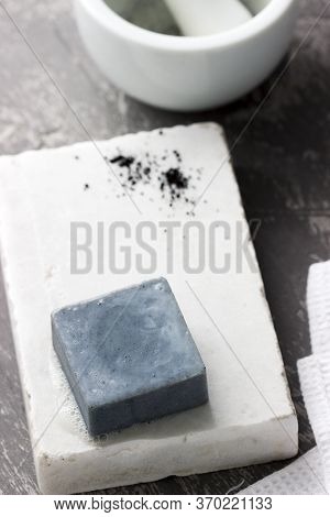 Handmade Soap With Activated Carbon On Marble, Carbon Powder And A Cotton Towel On A Gray Background