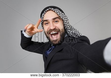 Close Up Of Arabian Muslim Businessman In Keffiyeh Kafiya Ring Igal Agal Suit Isolated On Gray Backg