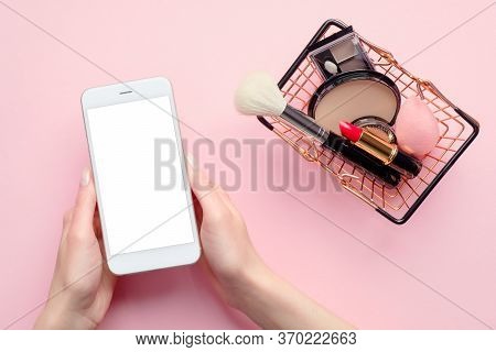 Buying Beauty Products Online Concept. Female Hand Holding Mobile Phone With Blank Screen Mockup And