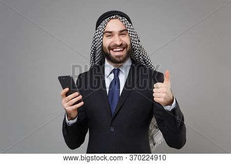 Joyful Arabian Muslim Businessman In Keffiyeh Kafiya Ring Igal Agal Classic Black Suit Isolated On G