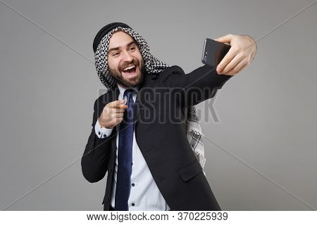 Arabian Muslim Businessman In Keffiyeh Kafiya Ring Igal Agal Suit Isolated On Gray Background. Achie