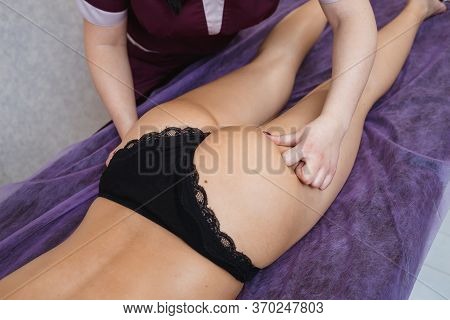 Doctor Specialist Massage Therapist Does Anti-cellulite Massage Of Legs And Buttocks To A Beautiful 