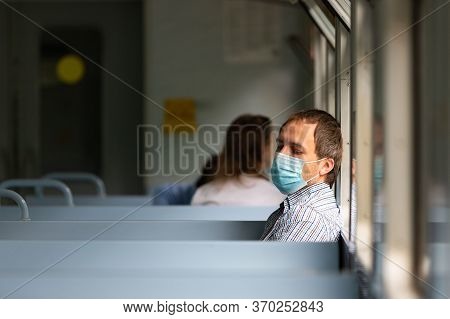 Sad Man Wears A Protective Mask In Train To Protect The Respiratory System From Coronavirus Infectio