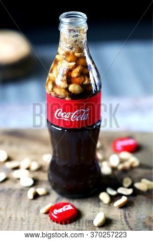Kharkiv / Ukraine - June 6 2020: Selective Focus. Macro. Coca Cola Bottle With Peanuts. Peanuts With