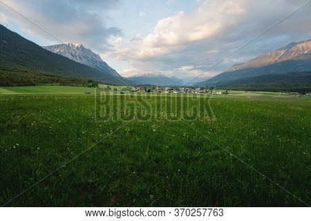 Panoramic View Over Flower Meadow To The Village Of Wildermieming During Sunset, Tyrol, Austria