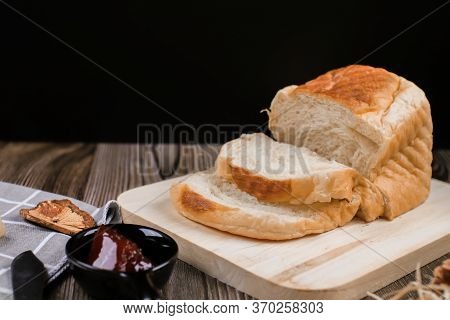Close Up Fresh Homemade Loafs Bread And Sliced Bread On Cutting Board With Jam Strawberry On Wooden 