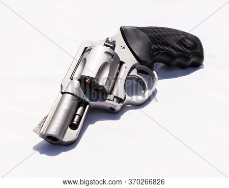 A Stainless Snub Nosed 357 Magnum Revolver On A White Background
