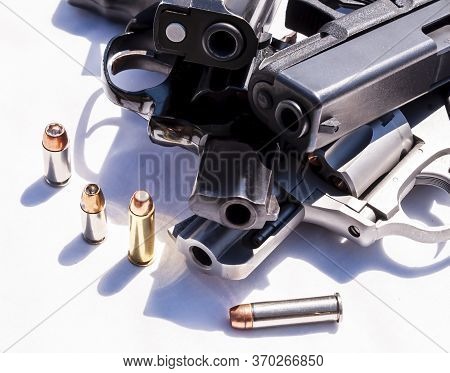 Four Handguns, Two Pistols A 9mm And 40 Caliber And Two Revolvers A 357 Magnum And A 38 Caliber With