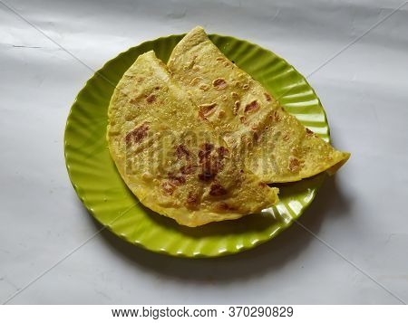Group Of Yellow Color Traditional Dal Obbattu Or Holige In A Plate Isolated On White Background