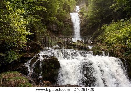 Idyllic Waterfall In Forest Crashing Over Rocks. Famous Waterfalls Giessbach In The Bernese Oberland