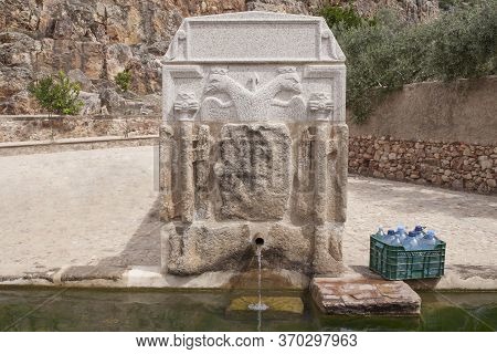 Box Full Of Bottles Ready To Be Filled At Palomas Pillar Fountain, Hornachos, Spain. Imperial Coat O