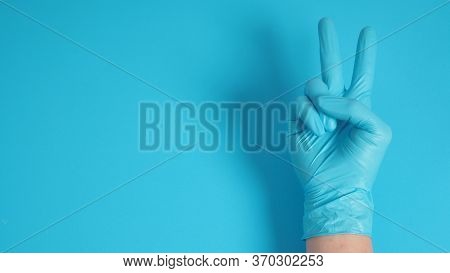 Peace Or Good Luck Sign.it Is Hand Gesturing Two Finger On Blue Background.