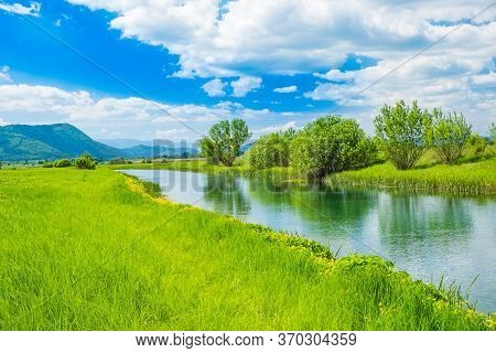 Croatia, Beautiful Nature Landscape, River Gacka Flowing Between The Meadow Fields In Lika Region