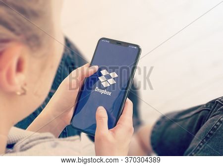 Kyiv, Ukraine-january, 2020: Dropbox On Mobile Phone Screen. Young Girl Pointing Dropbox During A Pa
