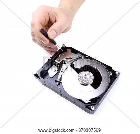 A Hand Repairs Hard Drive Isolated On A White Background. Man Hand With Screwdriver Fixing Hard Driv