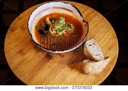 Bouillabaisse Seafood Soup With Fish, Shrimps, Squid, Mussles Inthe White Bowl.