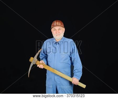 Male Laborer With Building Tools. Construction Worker Holds Pickaxe. Man Contractor With Axe. Smilin