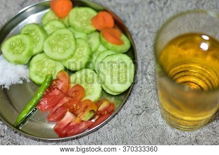 An Inverted Glass With Whisky, Red Tomatoes, Fresh Cucumber, Red Pepper, Parsley On A Plate. Selecti