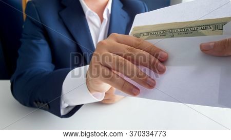 Closeup Image Of Corrupted Male Politician Taking Money Bribe In Envelope. Concept Of Corruption In 