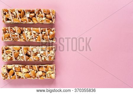 Almond Protein Granola Bars On Pink Background. Healthy Snack For Fitness, Sport People