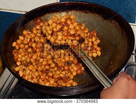 Preparing Delicious Indian Punjabi Choley Or Chola (chickpea) On A Round Pan. North Indian Tradition