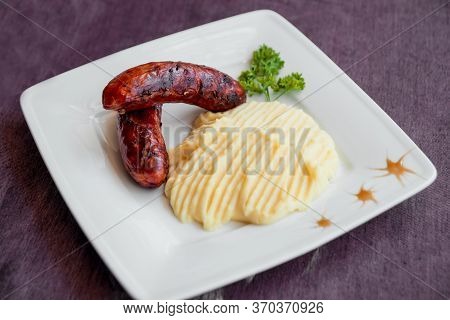 Potatoe With Sousages On The White Plate