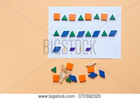 A Game. Lay Out Wooden Blocks According To The Shape, Color Indicated In The Table. The Development 