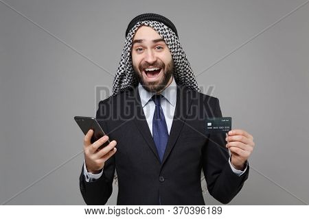 Excited Bearded Arabian Muslim Businessman In Keffiyeh Kafiya Ring Igal Agal Classic Suit Isolated O