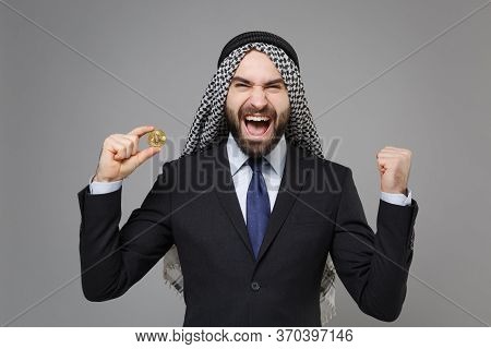 Happy Arabian Muslim Businessman In Keffiyeh Kafiya Ring Igal Agal Suit Isolated On Gray Background.