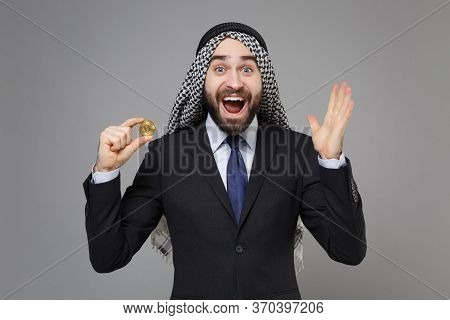 Surprised Arabian Muslim Businessman In Keffiyeh Kafiya Ring Igal Agal Black Suit Isolated On Gray B