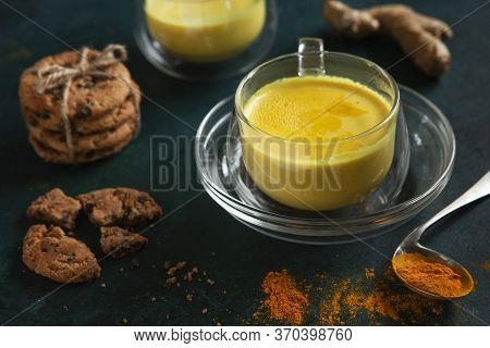 Cup Of Ayurvedic Drink Golden Milk Turmeric Latte With Curcuma Powder, Ginger And Honey Over Green T