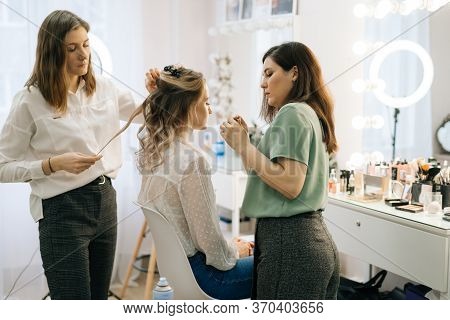 Portrait Of Two Professional Make-up Artist Doing Makeover In Lighting Dressing Room. Concept Of Bac