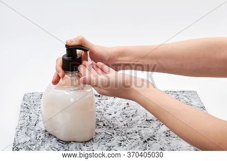 Girl Hands Using Hand Sanitizer Or Liquid Soap. Light Background. Viral Disease Prevention