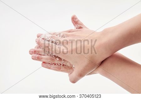 Coronavirus Or Covid-19 Concept. A Small Girl Washing Hands With Soap. Process Of Hand Washing With