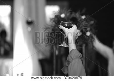 The Girl On Holiday Says A Toast And Raises A Glass, Black And White Photo. Celebration, Drink Alcoh