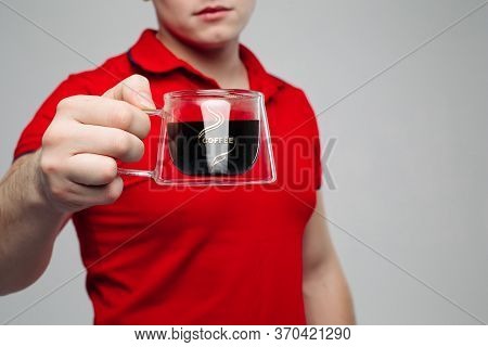 Close Up Of Young Man Hand Holding Creative Transparent Cup.