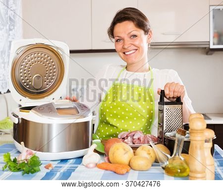 Smiling Housewife Using New Slo-cooker At Home