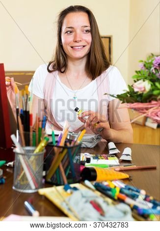 Portrait A Cheerful Young Artist Paints A Picture At Home