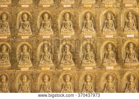 Puli, Taiwan - May 3th, 2020: golden buddhist sculpture on the wall at Chengte Foshan, Puli township, Nantou, Taiwan