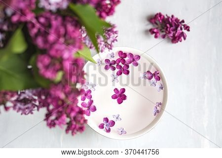 Five-pointed Lilac Flower Among Lilac Flowers In A Cup With Water. Spa Ritual. Lilac Branch With A F