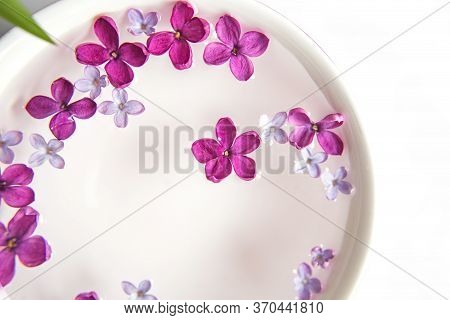 Five-pointed Lilac Flower Among Lilac Flowers In A Cup With Water. Spa Ritual. Lilac Branch With A F