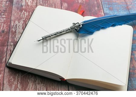 Notepad With Fountain Pen On Wooden Background