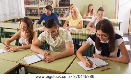 Young Beautiful Students Studying In The Classroom Interior