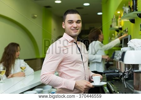 Smiling Barista Serve Coffee And Bartenter At Background