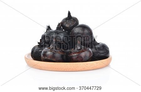 Waternut In Wooden Dish Isolated On White Background