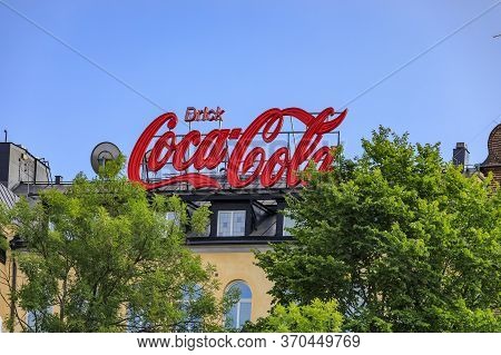 Stockholm, Sweden - August 27 2017: Large Classic Drink Coca Cola Advertisement Sign In Swedish Atop