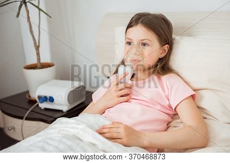 Kid With Cystic Fibrosis Lying In A Bed With Nebulizer Mask