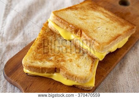 Homemade Grilled Cheese Sandwich On A Rustic Wooden Board , Side View. Close-up.